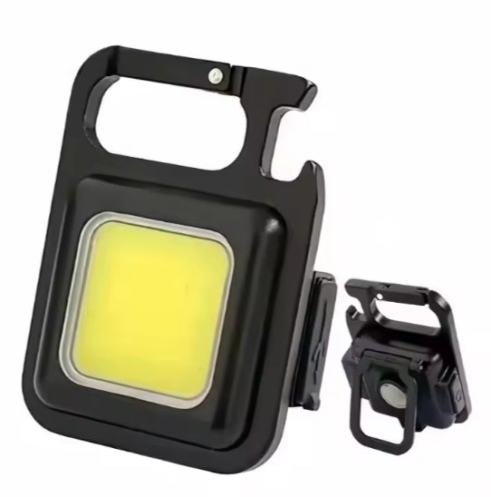 Mini Magnetic Light  COB L.E.D shown with its kick stand deployed and facing the viewer - smaller picture in the bac ground showing the  reverse of the light 